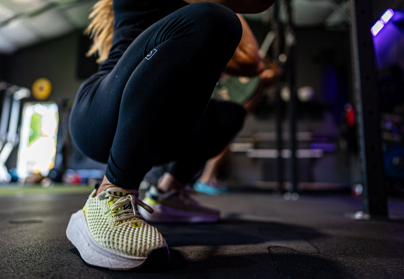 Athlete in a deep squat on the gym floor