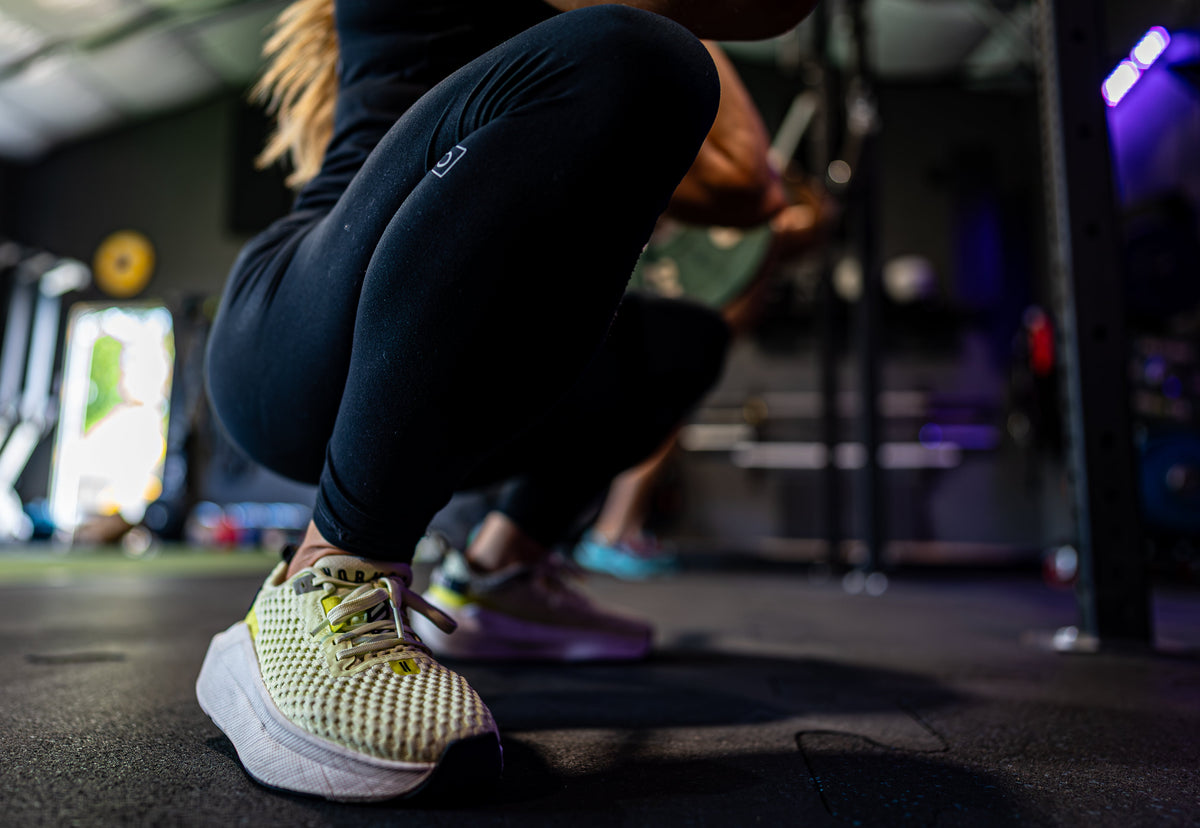 Athlete in a deep squat on the gym floor